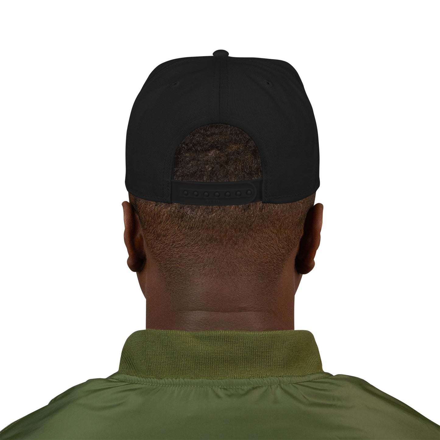 Back view of a person wearing a black snapback hat and green jacket.