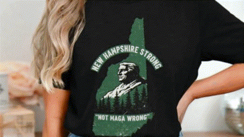 A woman wearing a black t-shirt with a graphic design of a man's face and the text "New Hampshire Strong" printed on it.