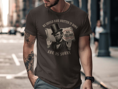 Brown t-shirt with "No Felons Abe is Sorry" text and Abraham Lincoln graphic.