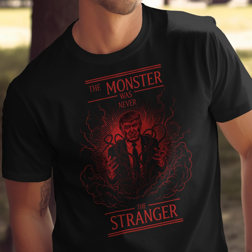 Black t-shirt with red text and a man's face depicted as a monster.