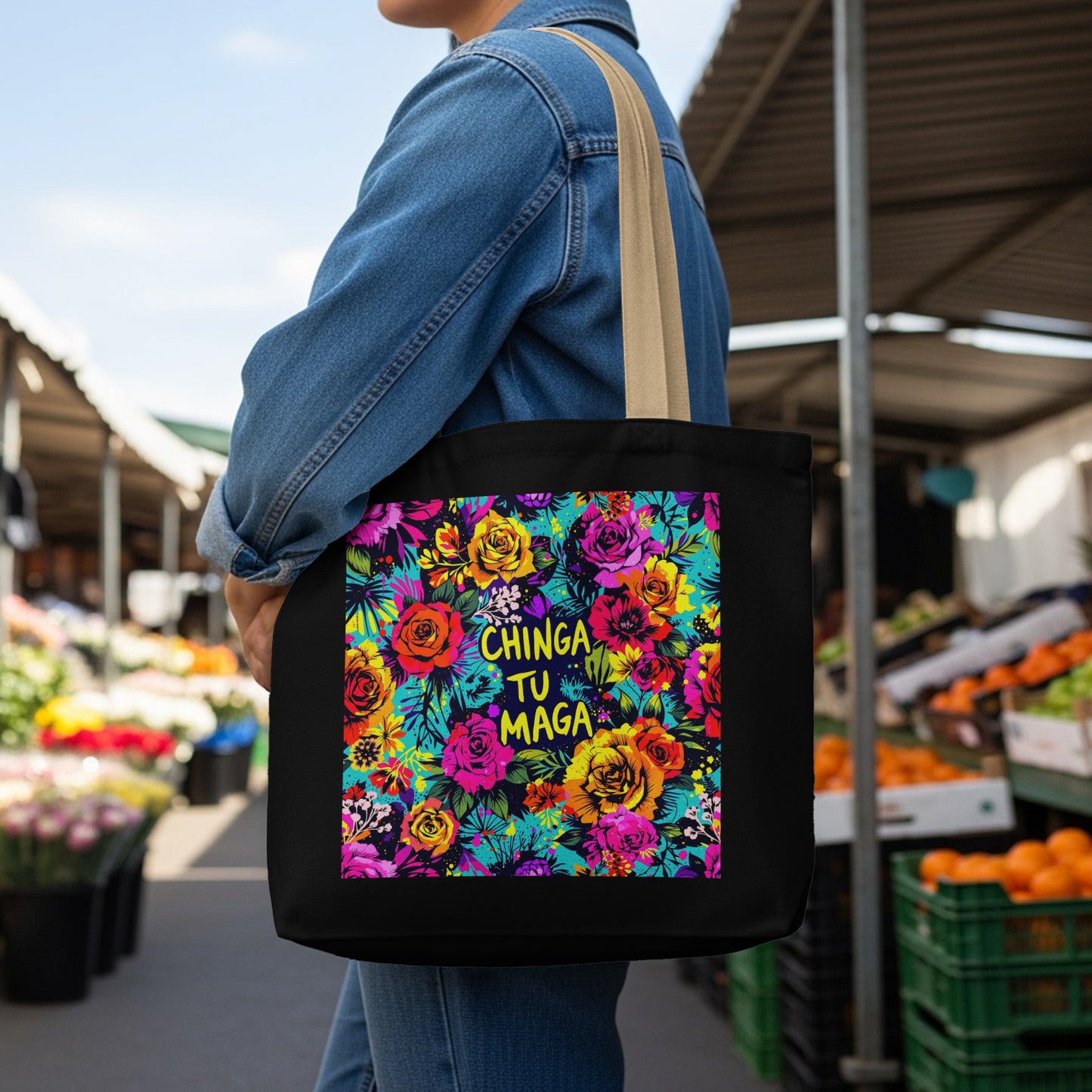 Black tote bag with colorful floral design and "chinga tu maga" text.