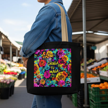 Black tote bag with colorful floral design and "chinga tu maga" text.