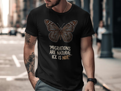 Black t-shirt with monarch butterfly graphic and text "MIGRATIONS ARE NATURAL. ICE IS NOT."