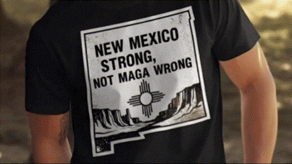 a person wearing a black t-shirt with a graphic design on the back, featuring a message about New Mexico.
