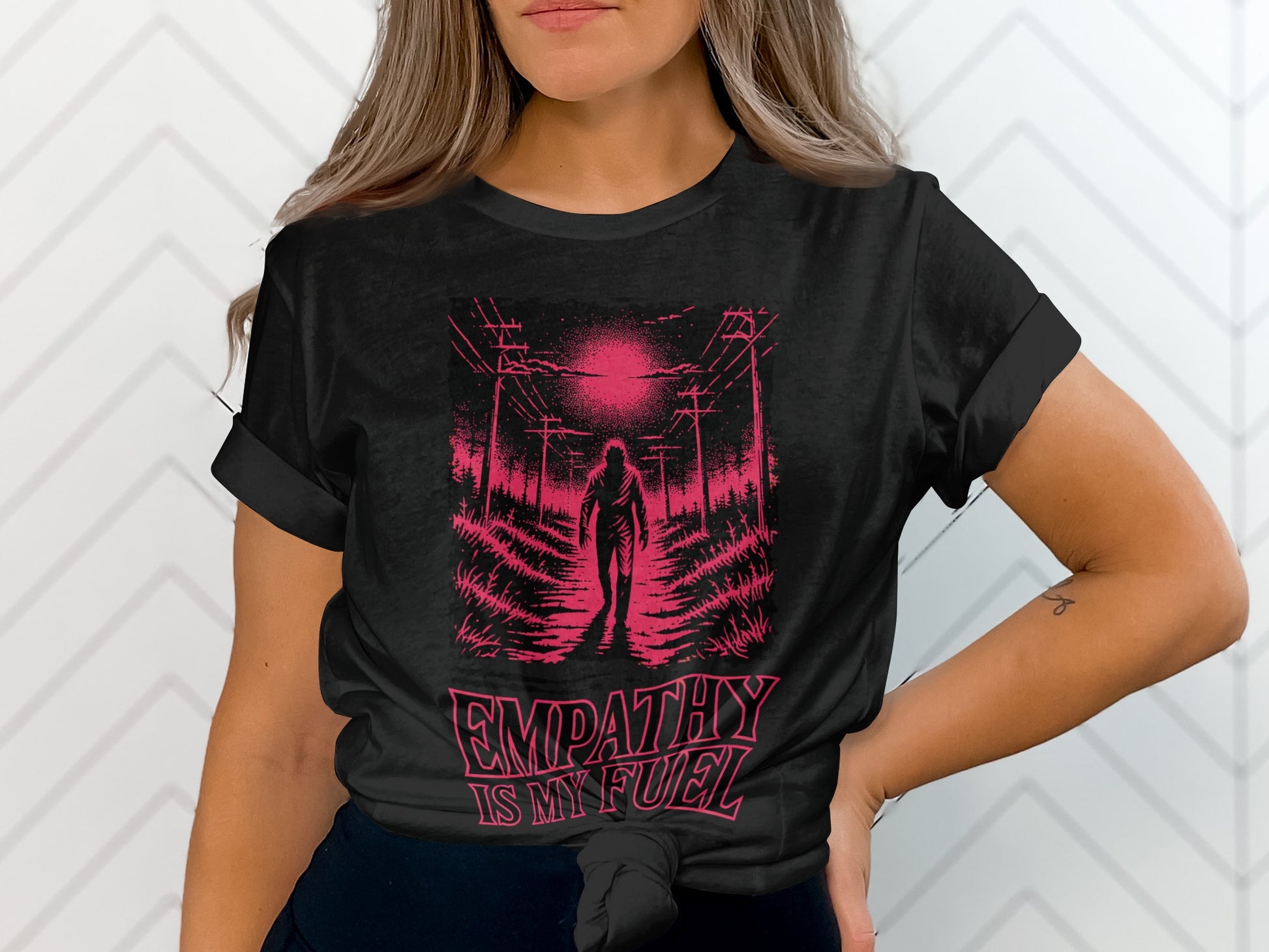 Black t-shirt featuring a silhouette of a figure walking down a path with power lines and the text "EMPATHY IS MY FUEL".