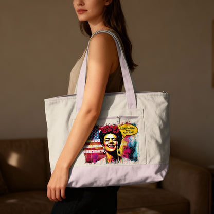 Woman holding tote bag with colorful graphic of woman, American flag, and text.