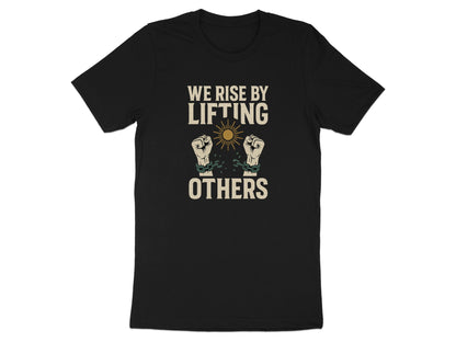 Black t-shirt with text "WE RISE BY LIFTING OTHERS" and raised fists breaking chains.