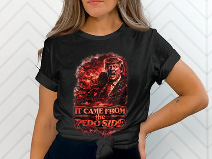 Black t-shirt with graphic of Donald Trump depicted as a monster with red eyes and fiery smoke. Text reads "It Came From the Pedo Side".