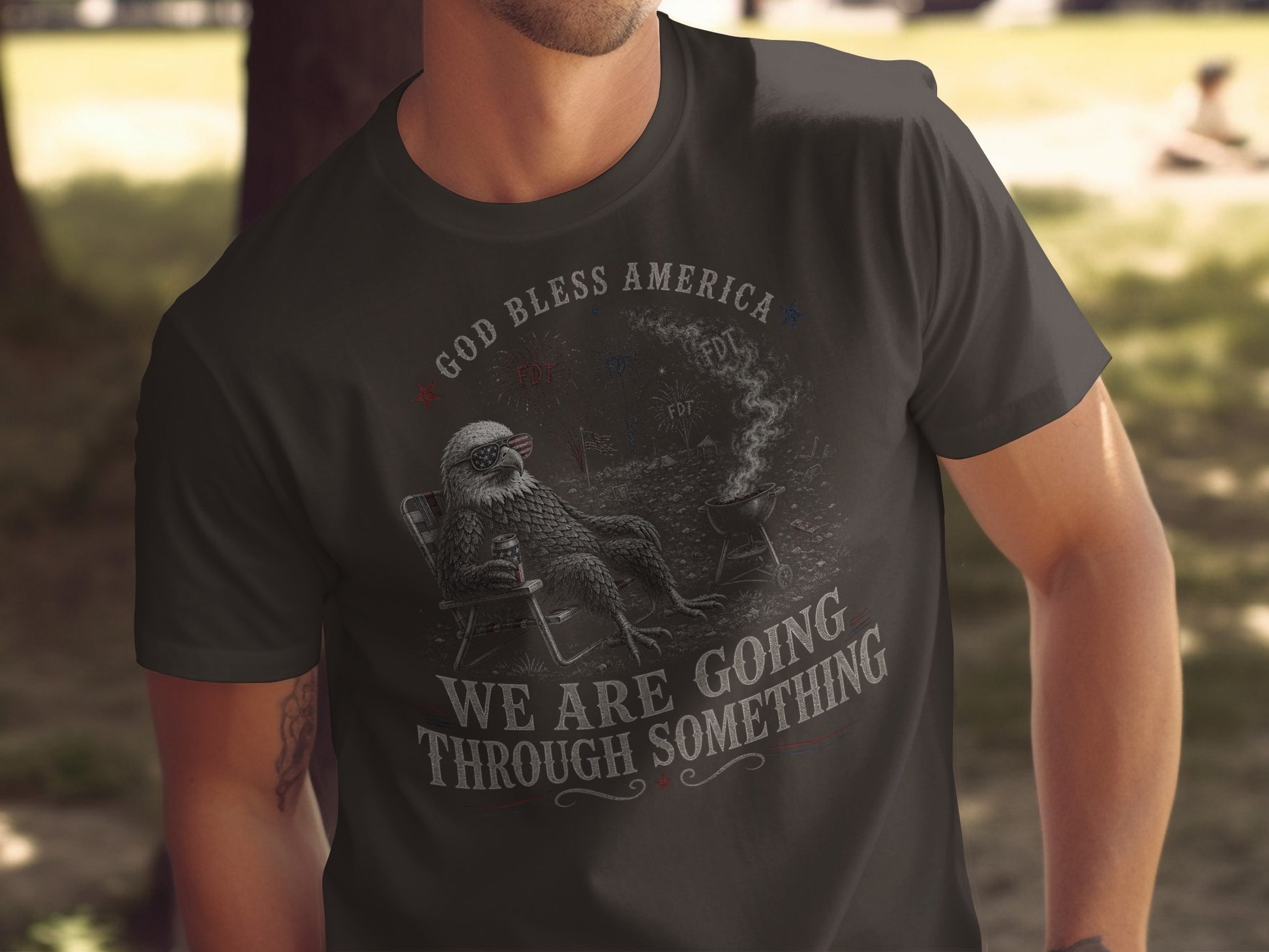 Dark t-shirt with eagle on chair and grill, "GOD BLESS AMERICA WE ARE GOING THROUGH SOMETHING".