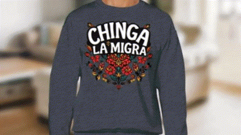 A person wearing a blue sweatshirt with the text "CHINGA LA MIGRA" printed on it.