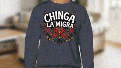 A person wearing a blue sweatshirt with the text "CHINGA LA MIGRA" printed on it.