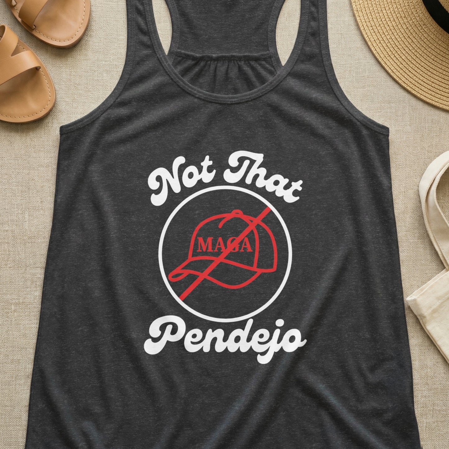 Dark grey tank top with "Not That Pendejo" and crossed-out MAGA hat graphic.