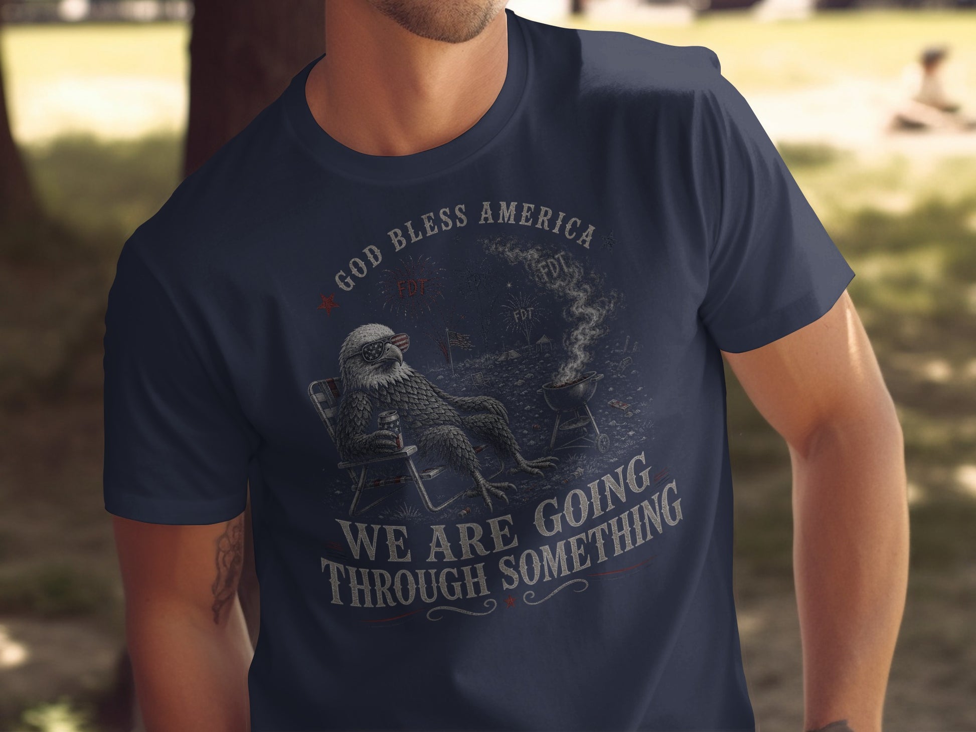 Navy t-shirt with eagle in chair, grill, and "God Bless America" text.