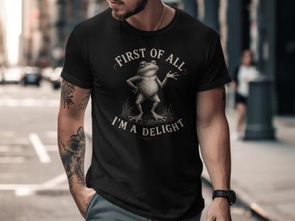 Black t-shirt with "First of all, I'm a delight" and a frog graphic.