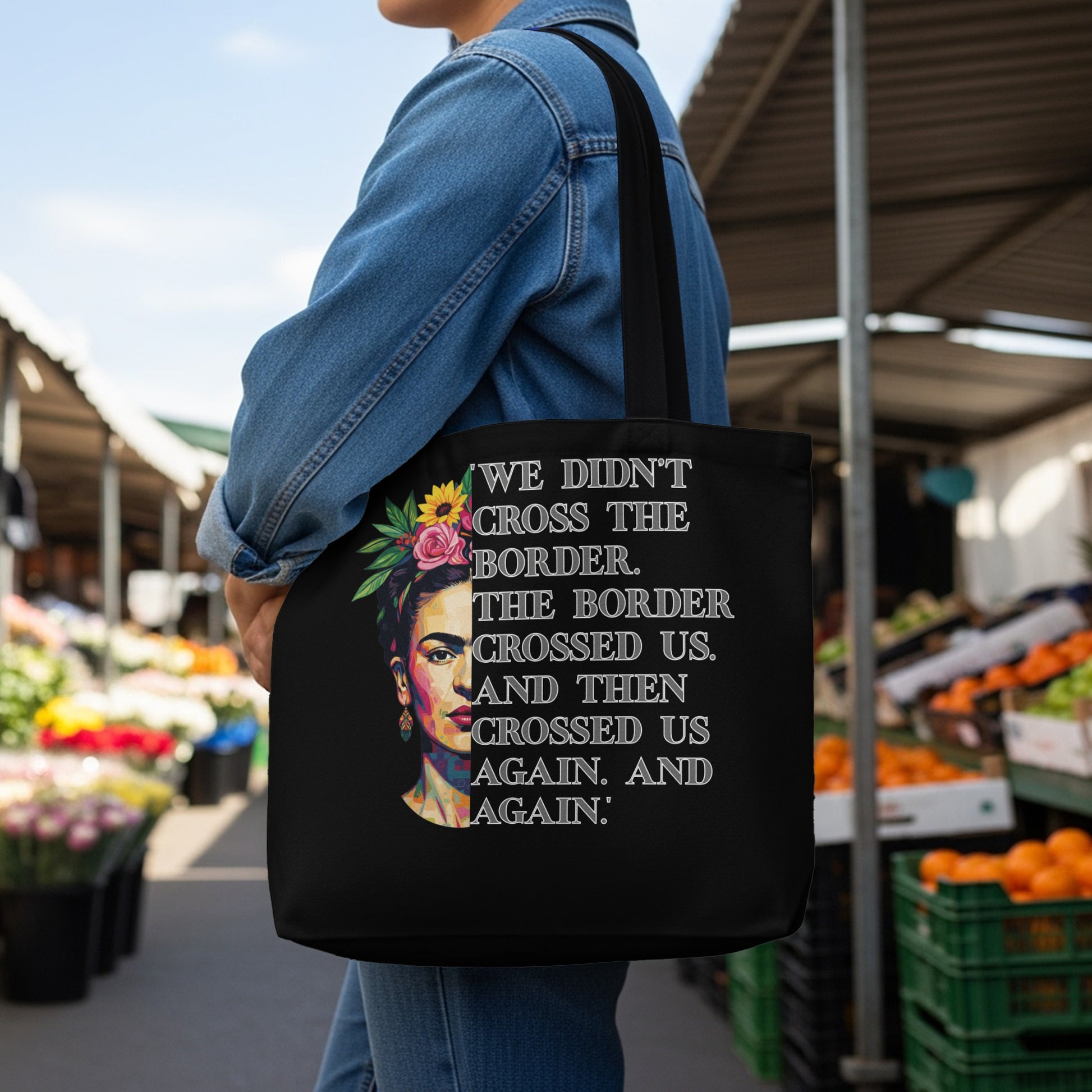 Black tote bag with Frida Kahlo portrait and "The border crossed us" text.