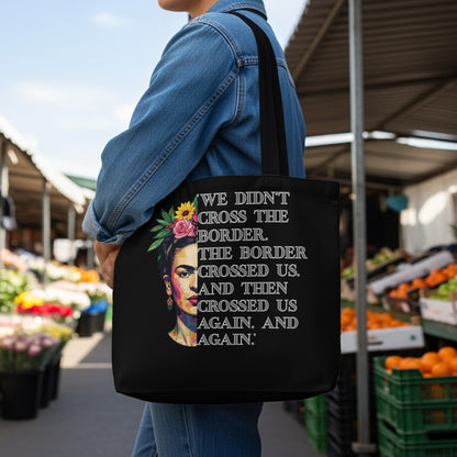 Black tote bag with Frida Kahlo portrait and "The border crossed us" text.