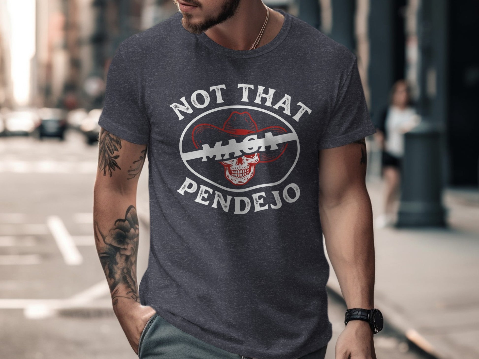Dark t-shirt with white text "NOT THAT MAGA PENDEJO" and a cowboy hat skull graphic.