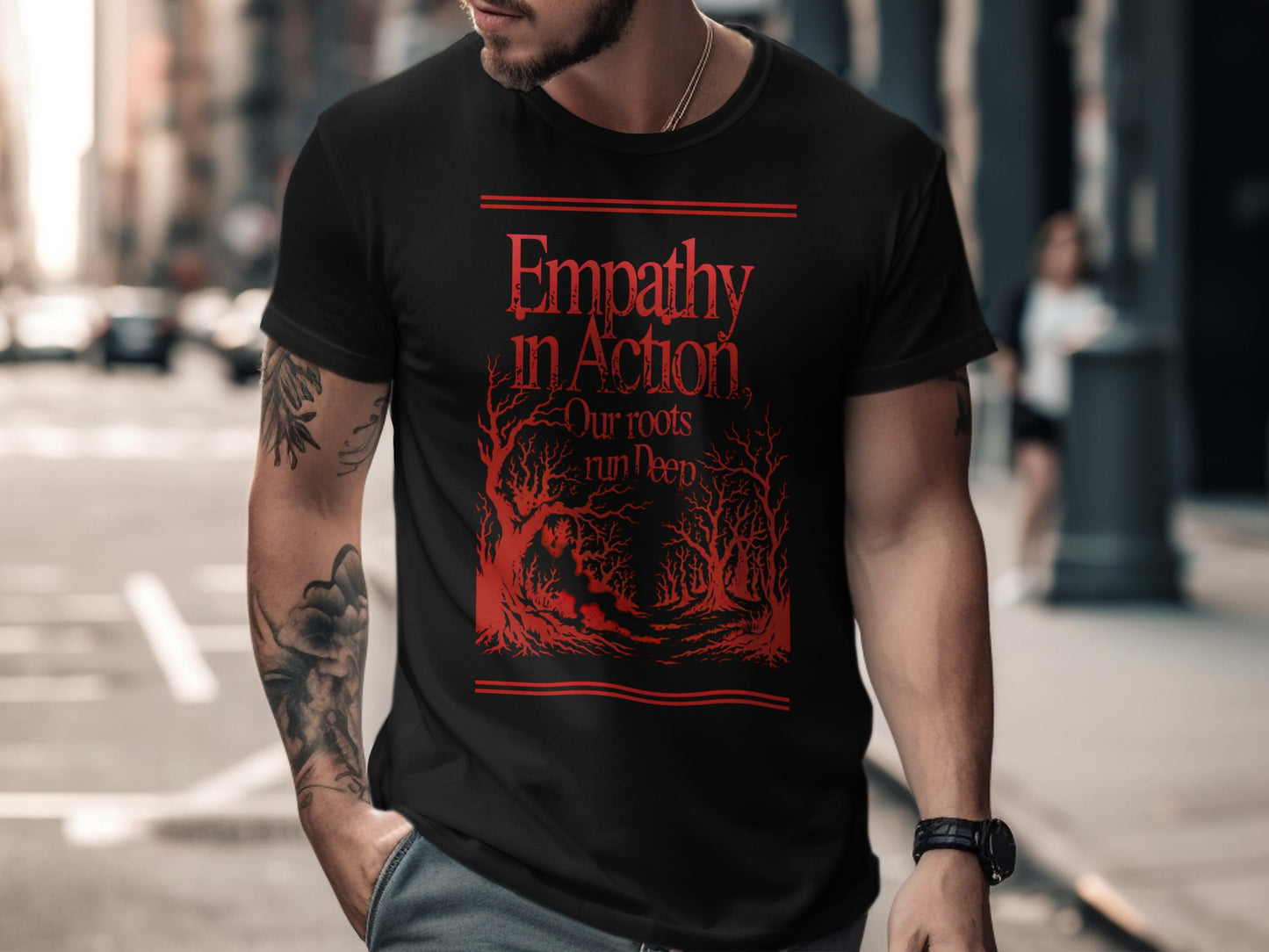 Black t-shirt with red text and stylized trees: "Empathy in Action Our roots run deep"