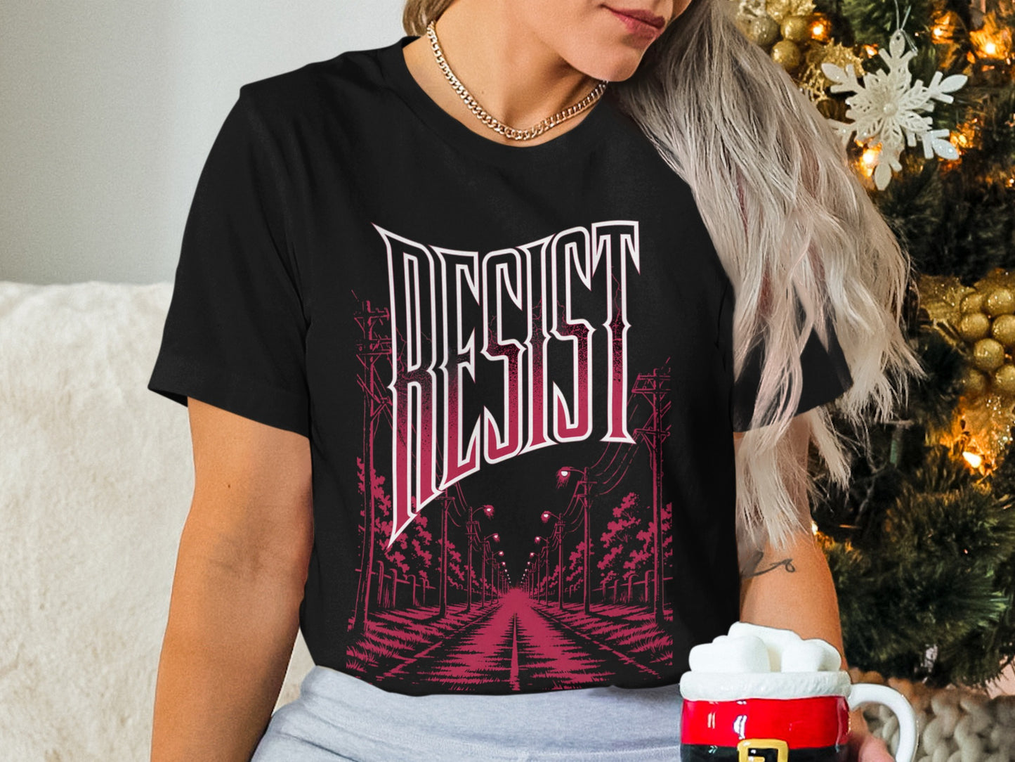 Black t-shirt with "RESIST" text and a street scene graphic.