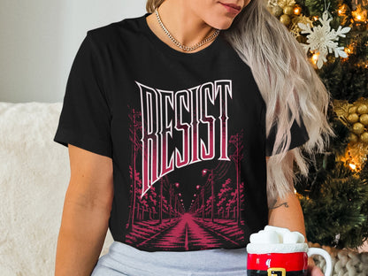 Black t-shirt with "RESIST" text and a street scene graphic.
