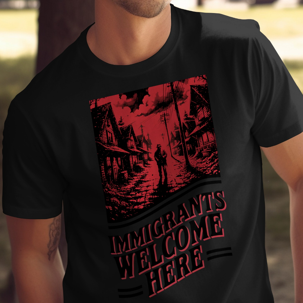 Black t-shirt with "IMMIGRANTS WELCOME HERE" text and a dark, silhouetted street scene.