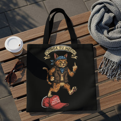 Black tote bag with a cartoon cat wearing a bandana and jacket, giving the middle finger on a red hat.