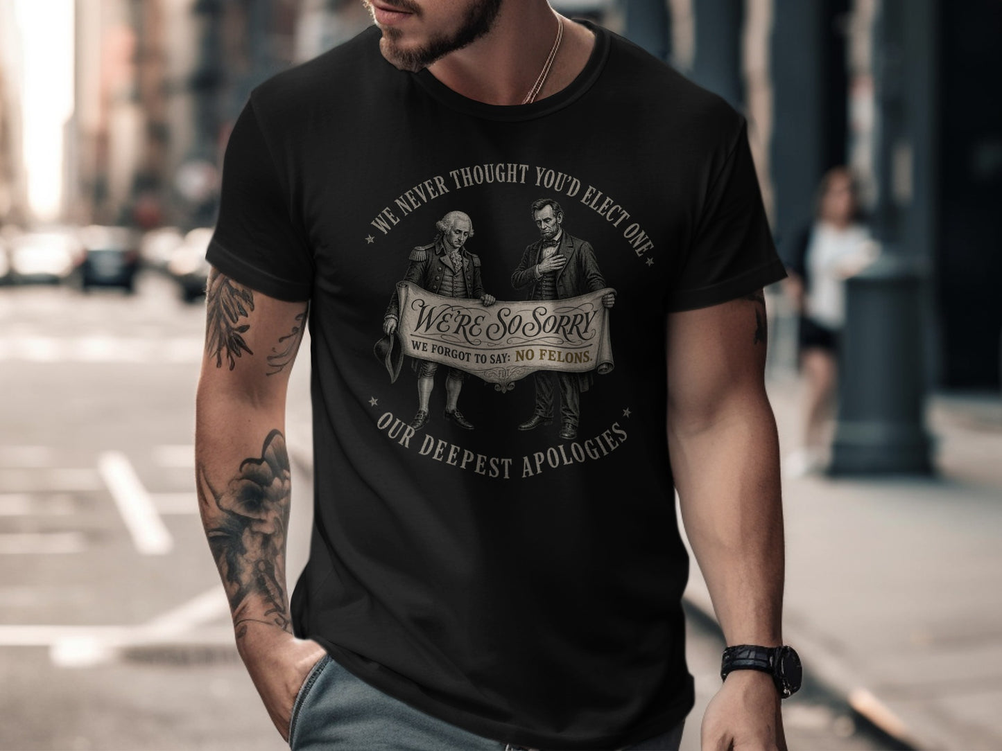 Black t-shirt with historical figures and text about elections and apologies.