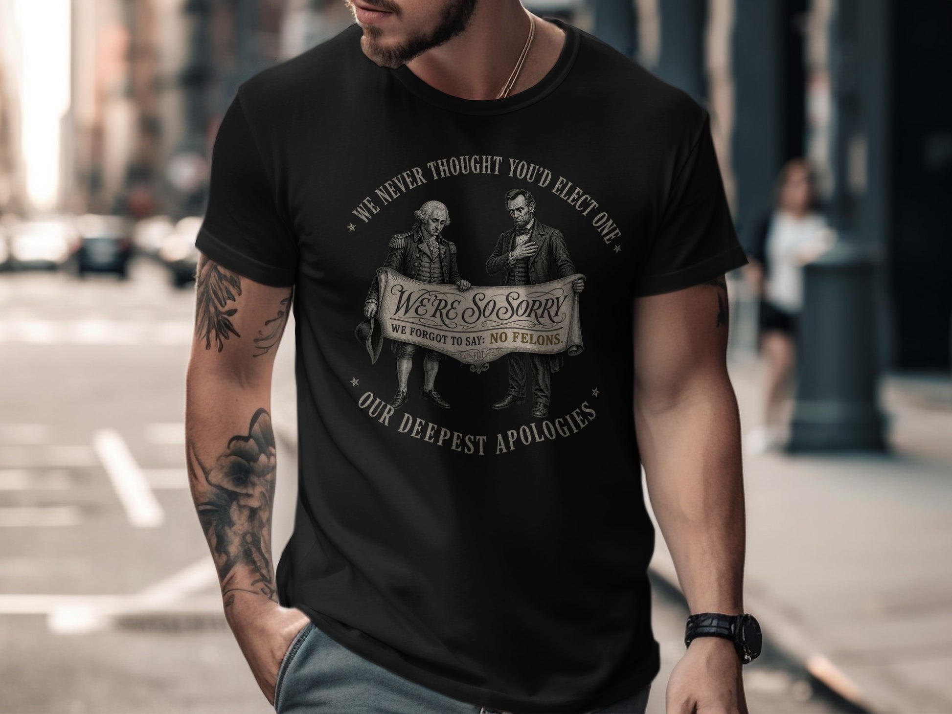 Black t-shirt with historical figures and text about elections and apologies.