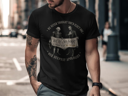 Black t-shirt with historical figures and text about elections and apologies.