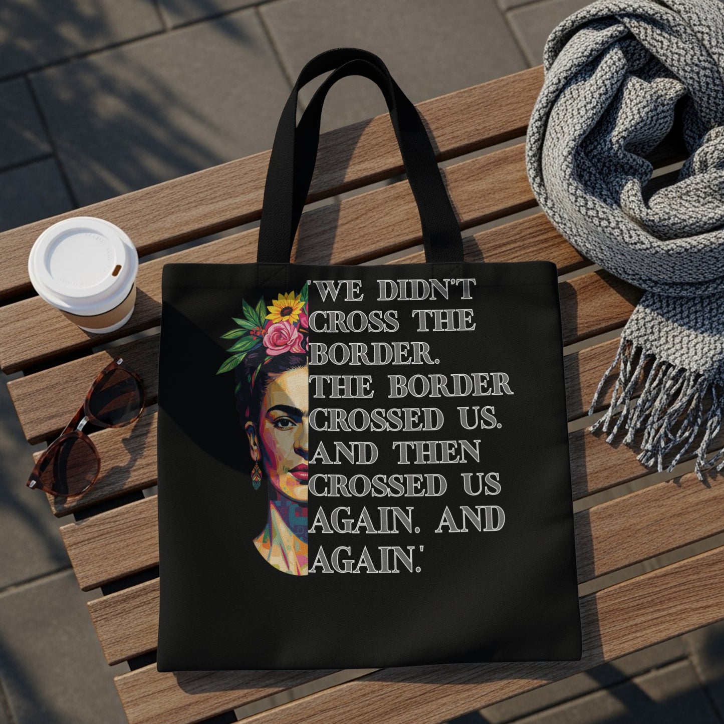 Black tote bag featuring Frida Kahlo portrait and quote about crossing borders.