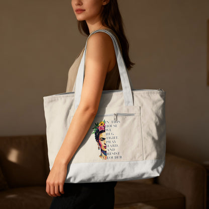 Tote bag with Frida Kahlo graphic and text "in this house we hug fight pray hard and resist louder."