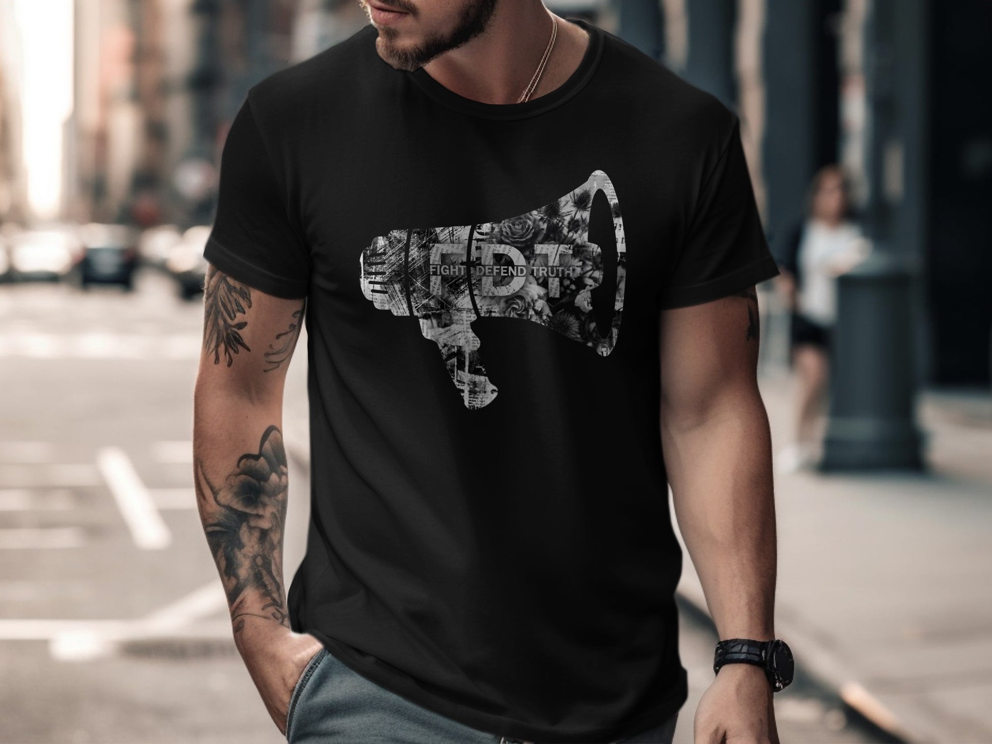 Black t-shirt with a distressed megaphone graphic filled with newsprint.