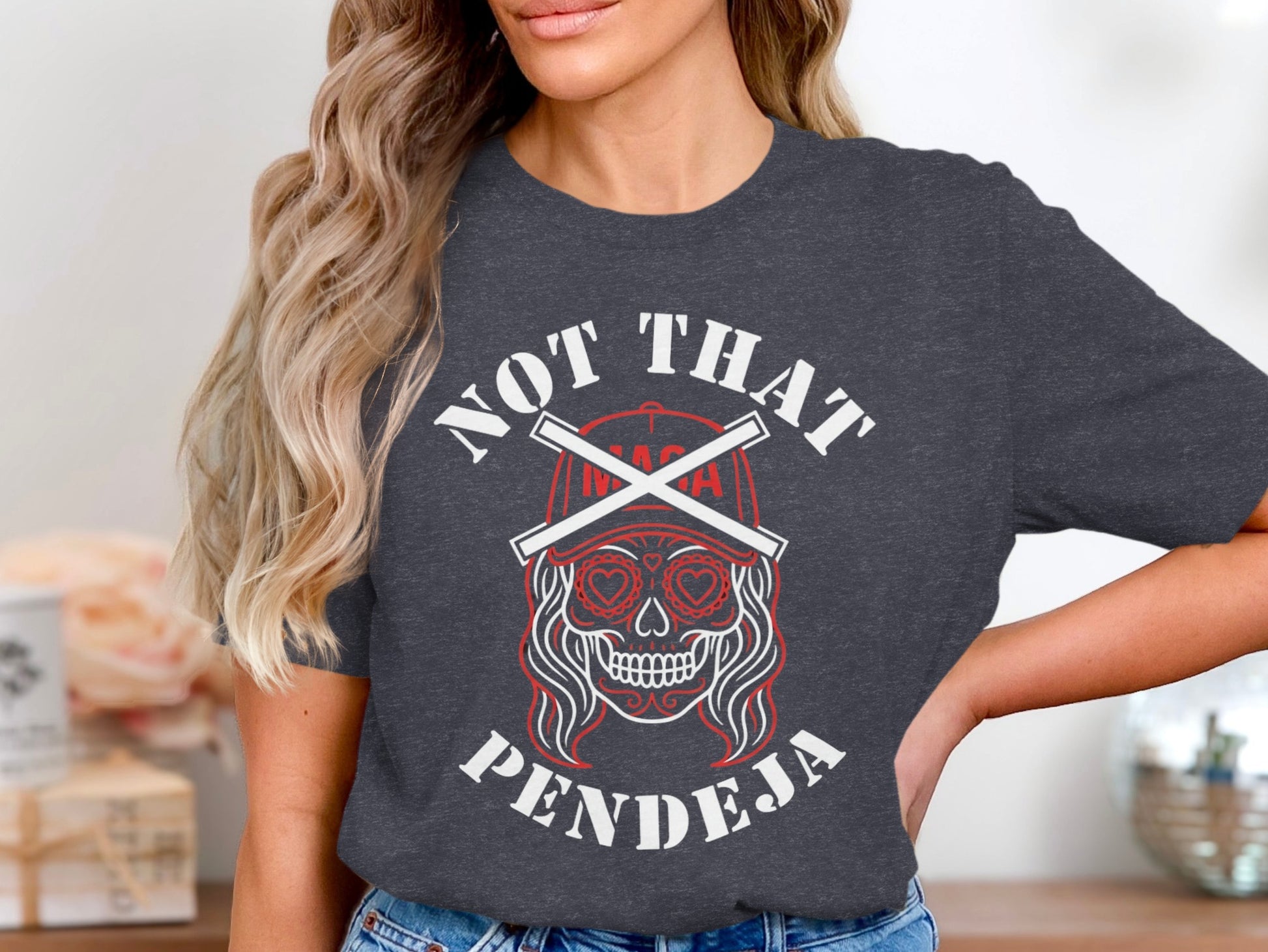 Dark grey t-shirt with "Not That Pendeja" text and skull graphic.