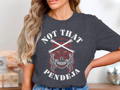 Dark grey t-shirt with "Not That Pendeja" text and skull graphic.