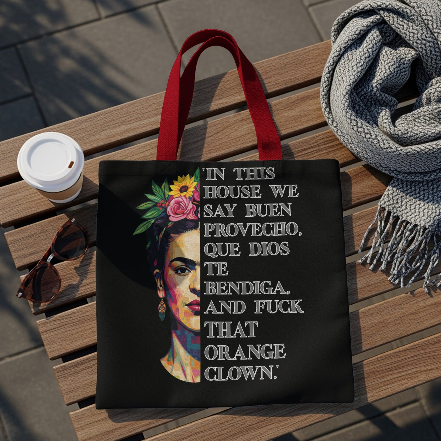Tote bag with Frida Kahlo graphic and Spanish text about blessings and an orange clown.