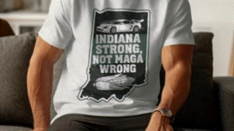 A person wearing a white t-shirt with a graphic design on it, sitting on a couch.