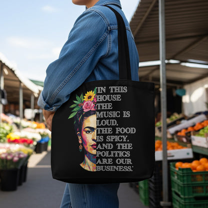 Black tote bag with Frida Kahlo art and "In this house the music is loud..." text.