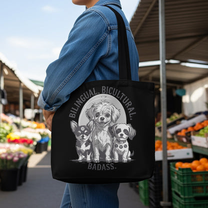 Black tote bag with three dogs and "Bilingual, Bicultural, Badass." text.