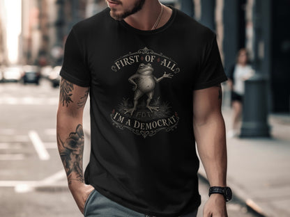 Black t-shirt with "First of All, I'm a Democrat" text and a frog graphic.