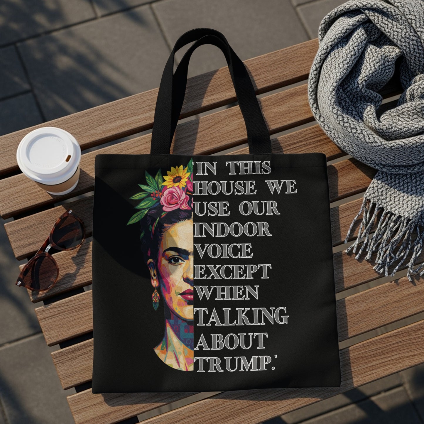 Black tote bag with Frida Kahlo portrait and text about using an indoor voice.