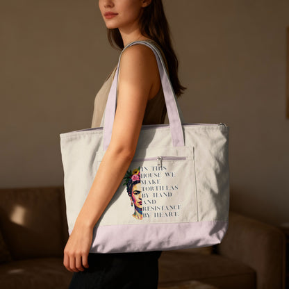 Tote bag with Frida Kahlo portrait and "tortillas by hand and resistance by heart" text.