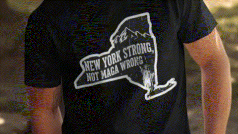 A black t-shirt with a graphic design on the back, depicting a map of New York State with the text "NEW YORK STRONG, NOT MAGA WRONG!" printed on it.