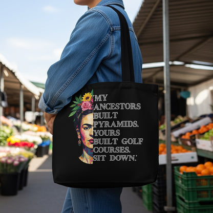 Tote bag featuring Frida Kahlo portrait and quote: "My ancestors built pyramids, yours built golf courses. Sit down."