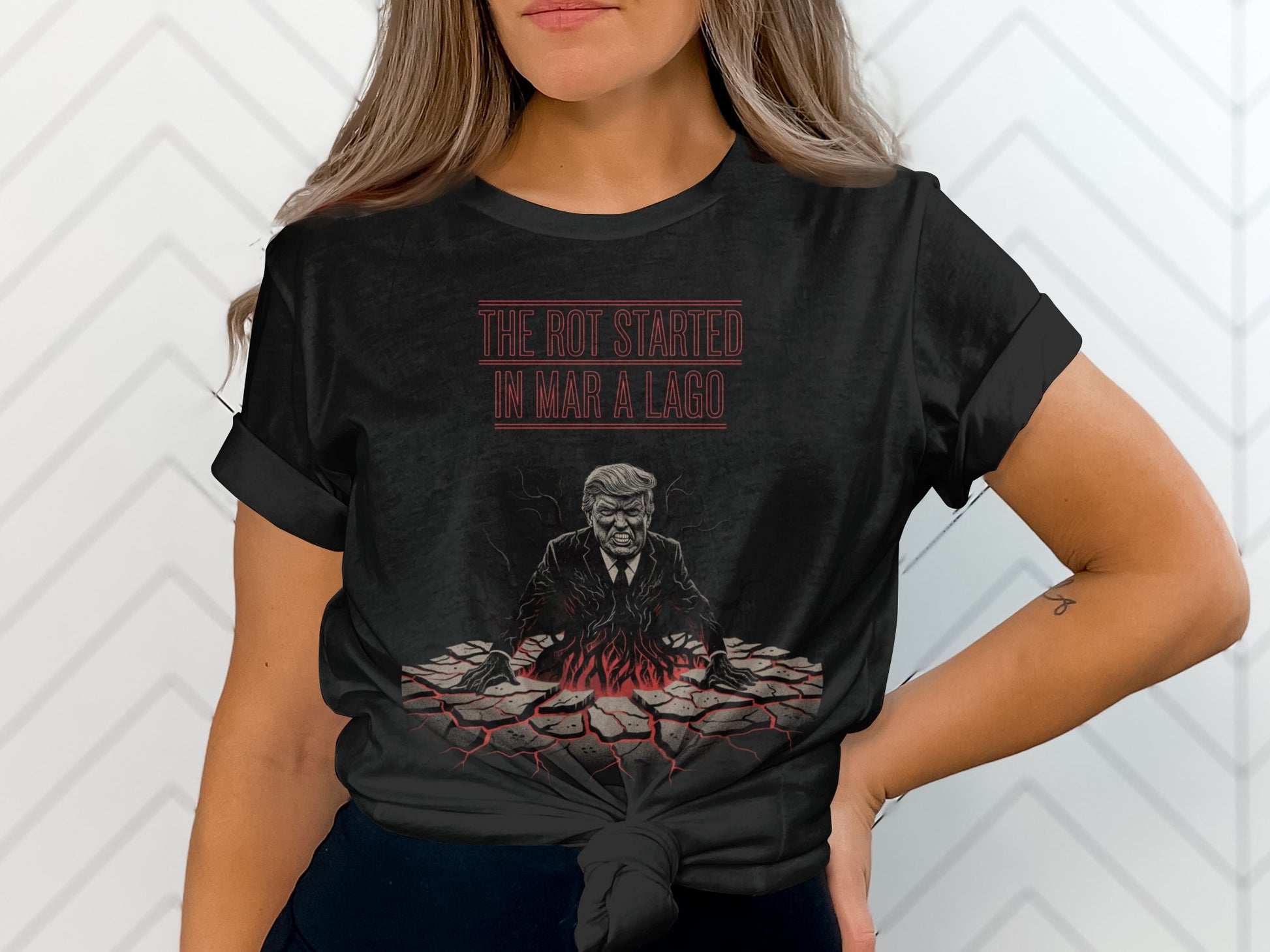 Donald Trump emerging from cracked ground on a black t-shirt.