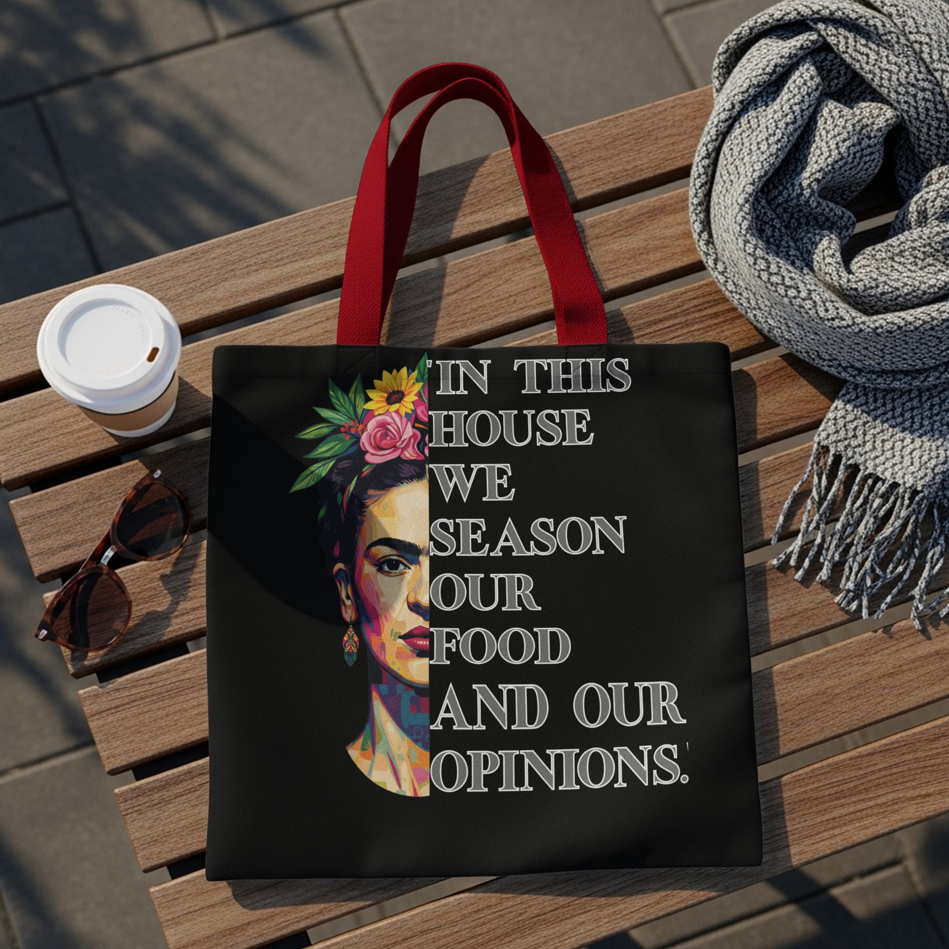 Black tote bag with Frida Kahlo portrait and quote.