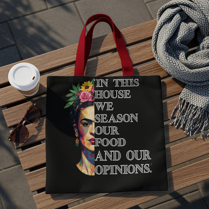 Black tote bag with Frida Kahlo portrait and quote.