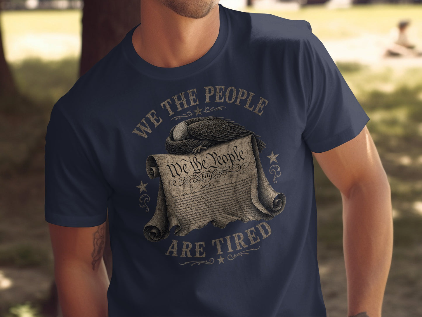 T-shirt with "We The People Are Tired" text and Constitution scroll with eagle.