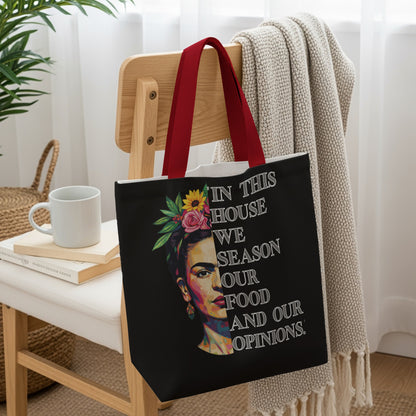 Black tote bag with Frida Kahlo portrait and quote.