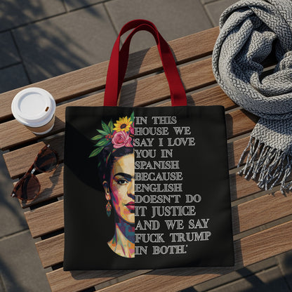 Black tote bag with Frida Kahlo portrait and bold feminist text.