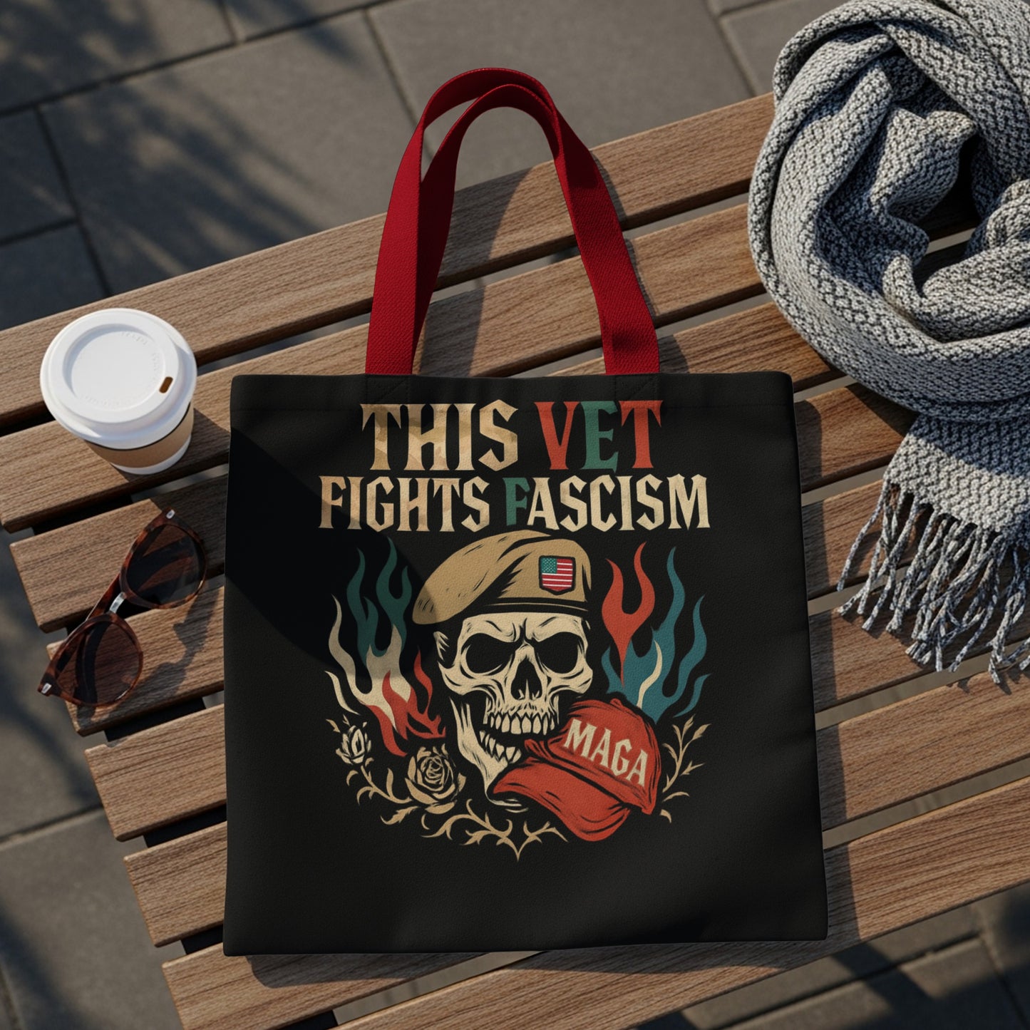 Black tote bag with skull, flag, and "This Vet Fights Fascism" text.